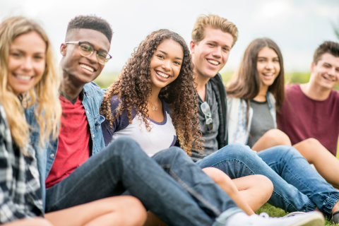 A group of teens smiling into the camera.