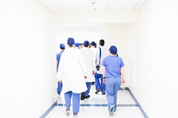 Professionals walking down hospital hallway