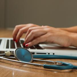 Doctor Typing on Computer