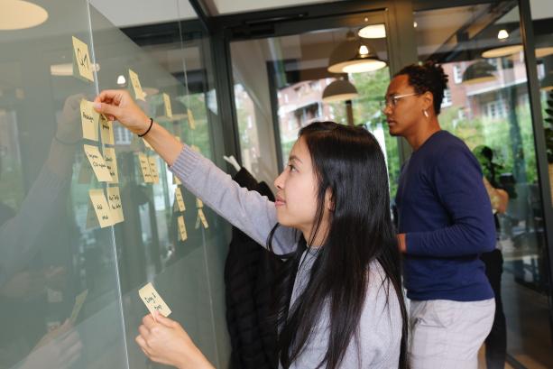 Colleagues putting up post-its