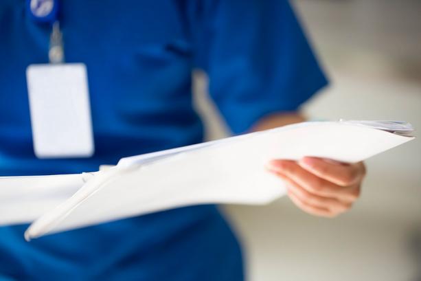 Hospital Nurse holding paperwork