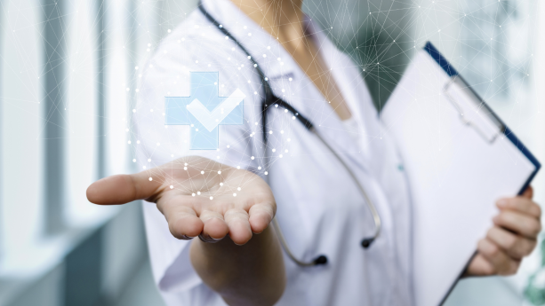 Photo of doctor holding out hand with medical symbol floating above it.