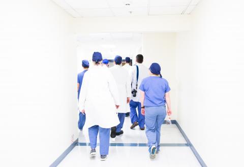 Professionals walking down hospital hallway