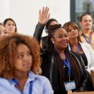 Woman holding up hand at training